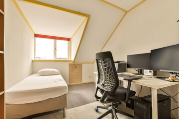 a room with a bed, desk and two computer monitors on the wall next to each other workstations