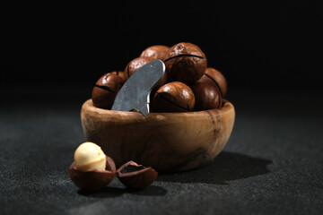 Macadamia nuts with a key on a black background.