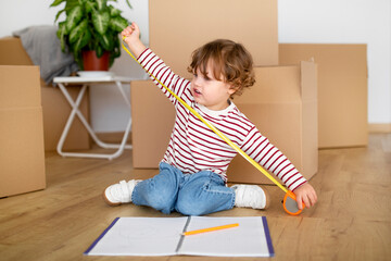 Future Interior Designer. Cute Little Boy Playing With Tape Ruler At Home
