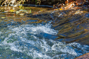 flow of water and spray from a stone