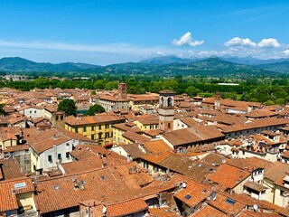 Overlooking view of Lucca, a fully walled Renaissance city in Tuscany, Central Italy. The walls play an important role in the cultural identity of the city of Lucca and its surroundings.  - obrazy, fototapety, plakaty
