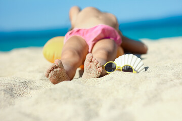 A feet of a happy child near the seashore in nature weekend travel