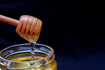 Honey drips beautifully from a honey spoon