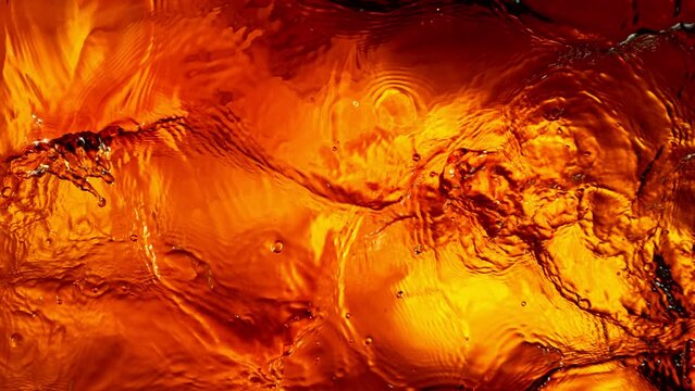 Super Slow Motion of Splashing Whiskey, Close-up. Filmed on High Speed Cinema Camera, 1000 fps. Top View Shot Composition.