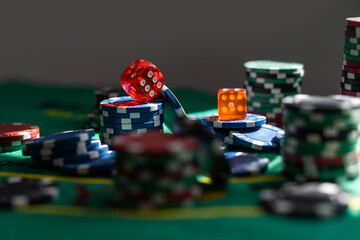 Stacks of gambling poker chips on green background, casino concept