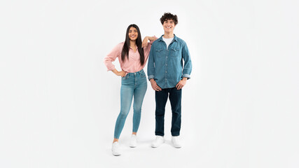 Obraz premium Happy Young Couple Posing Standing Over White Background, Full Length