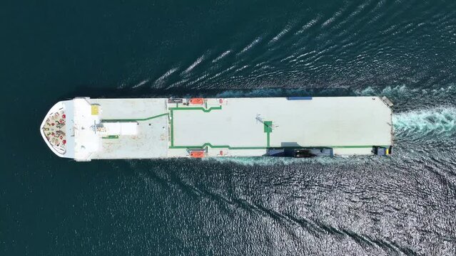 Aerial drone video of huge car carrier ship RO-RO (Roll on Roll off) cruising in Mediterranean deep blue Aegean sea