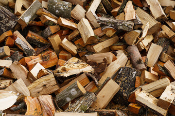 Dry chopped firewood in a pile. Abstraction and background