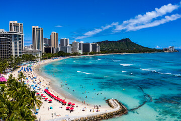 Paradise Found: Waikiki Coastline and Diamond Head Framed by Vibrant Red Beach Umbrellas