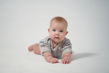 Portrait of a baby on a light background. baby lying on stomach