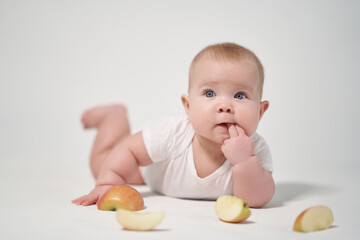 Baby 7 months among apple slices