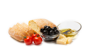 Ciabattas, olive oil in a bowl with olives, raspberry herbs, spices, garlic, cherry tomatoes, parmesan and ciabatta bread isolated on white background.Banner. Healthy food concept.Delicacy.