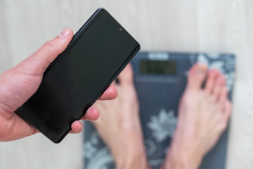 Male on the weight scale for check weight, Diet concept