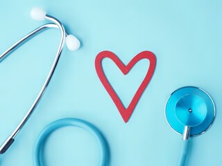Medical background with blue stethoscope and Red heart