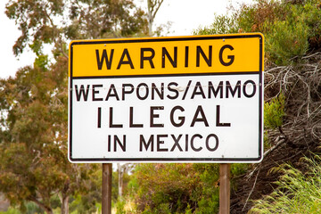 Sign on 5 freeway in San Diego warning that it is illegal to carry weapons or ammuntion into Mexico