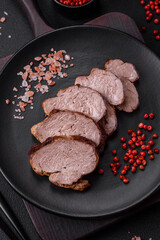 Delicious beef steak with salt, spices and herbs on a ceramic plate