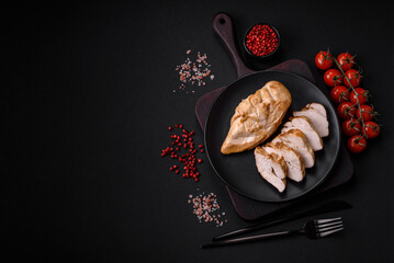 Delicious fresh grilled chicken fillet with salt, spices and herbs on a ceramic plate