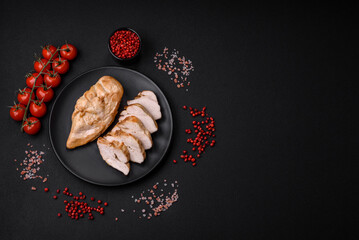 Delicious fresh grilled chicken fillet with salt, spices and herbs on a ceramic plate