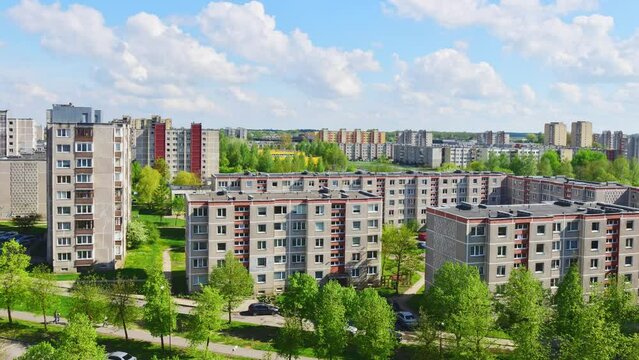 Static aerial summer time-lapse southern part of Siauliai city in Lithuania.Old soviet union buildings with green nature around and yards full of cars in sunny day