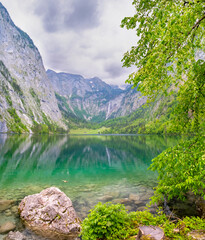 Green turquoise clear alpine lake Obersee Koenigssee surrounded by mountains Alps in Bavaria, Germany