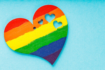 Rainbow heart on blue background. LGBT Pride month concept. Top view. Copy space