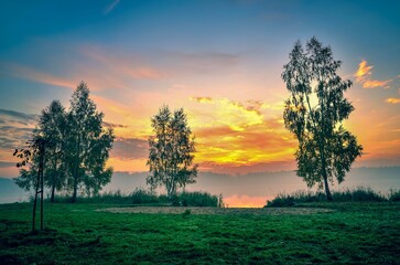 Fototapeta na wymiar Foggy colorful morning on the lake. Sunrise over Lake Paproacany in Tychy, Poland.