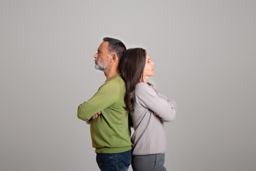 Fototapeta premium Sad unhappy angry offended european old lady ignores man, stand back to back
