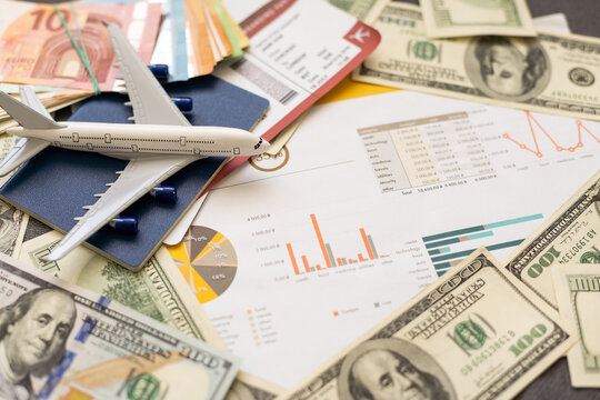 Toy plane on Euro cash background, travel with airplane. Conceptual image of the price of airline tickets for travel. Selective focue, close-up.