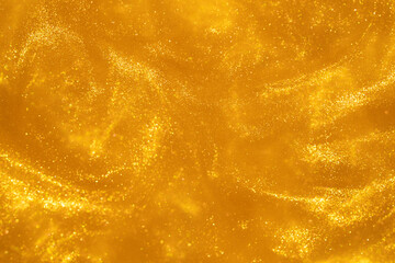 Atmospheric whirlwind of gold particles in fluid. Countless glistering sparkling particles in...