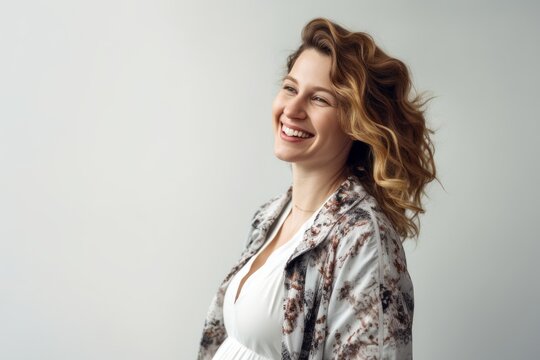 Medium shot portrait photography of a grinning pregnant woman in her 30s that is wearing a chic cardigan against a white background . Generative AI