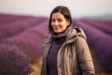 Portrait of a young woman in lavender field at sunset.