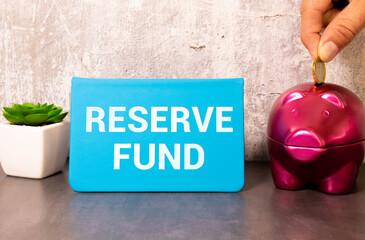 Business concept. On a white background, a pencil, coins and a sign with the inscription - Reserve Fund.