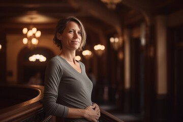 Fototapeta premium Portrait Of Mature Woman Standing In Lobby Of Hotel, Looking At Camera