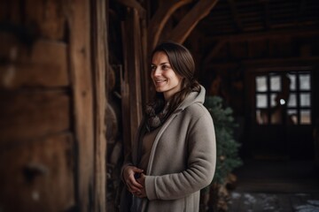 Fototapeta na wymiar Medium shot portrait photography of a cheerful pregnant woman in her 30s that is wearing a chic cardigan against a rustic barn or farm background . Generative AI