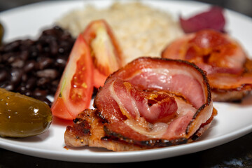Traditional Brazilian daily meal, black beans, rice, meat, salad. real food