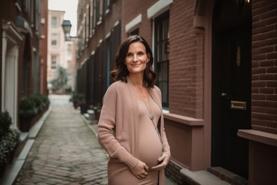 Group portrait photography of a cheerful pregnant woman in her 40s that is wearing a chic cardigan against an old building or architecture background . Generative AI