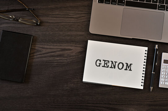 There is notebook with the word GENOM. It is as an eye-catching image.