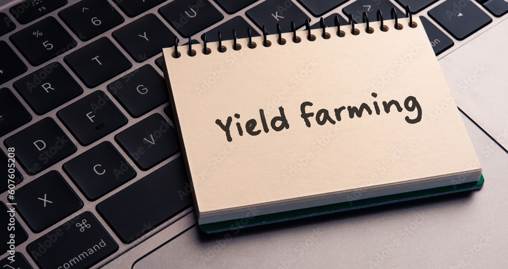 Poster there is notebook with the word yield farming. it is as an eye-catching image.