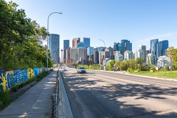 Views along Centre St Bridge in Calgary, Alberta on a blue sky day with city skyline in view, tower, sky scrapers in scenic skyscape landscape. 
