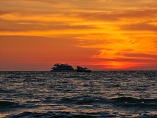 Fototapeta na wymiar Sunset in Gulf of Mexico with 2 boats, Clearwater