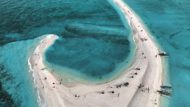 Aerial view of people on White Island along Camiguin Island coastline, Philippines.