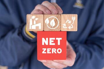 Man holding colorful blocks with icons and abbreviation: NET ZERO. Net zero and carbon neutral...