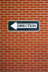 Fototapeta premium Direction sign on brick wall.