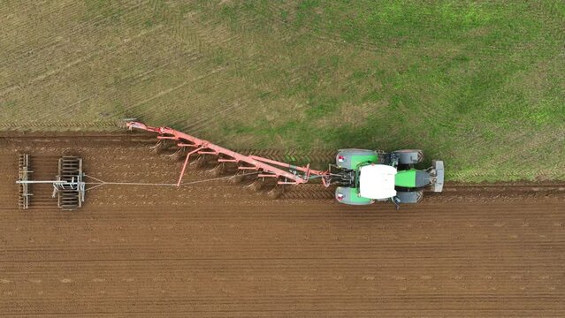 Aerial view of a tractor ploughing at a farm in Brandenburg, Germany.