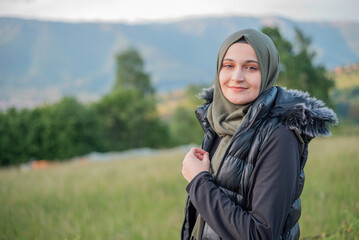 Fototapeta na wymiar Peaceful beauty, a stunning portrait of a young Muslim woman in nature