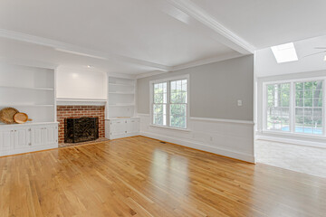 Fototapeta na wymiar Beautiful Modern Empty Family Room Interior with Hardwood Floors and Natural Light