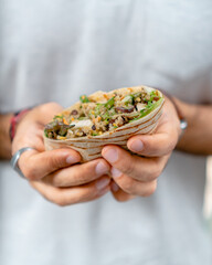 Chicken wrap in men's hands
