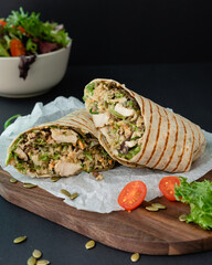 Chicken wrap with quinoa and pumpkin seeds. Healthy balanced food full with protein
