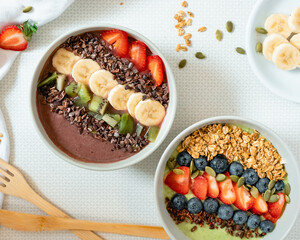 Smoothie Bowls. Trendy breakfast. Healthy lifestyle. Strawberry, blueberry, kiwi, granola, pumpkin seeds