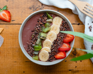 Smoothie bowl with fresh fruits and chocolate beans 